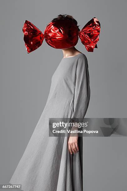 Woman with big candy in front of her face