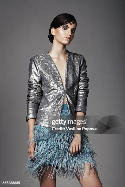 beautiful fashionable woman posing in studio - silver dress photos et images de collection