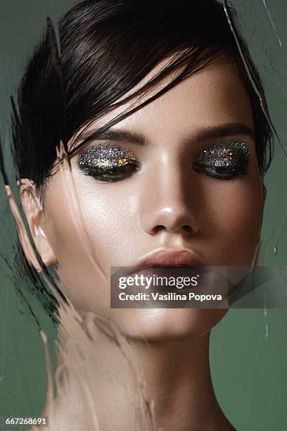 beautiful woman behind wet glass - blank face stock-fotos und bilder