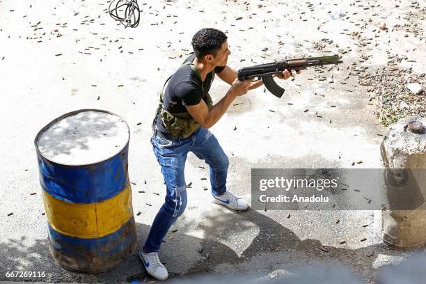 An Al-Fatah Movement militant is seen during a fire exchange as clashes between members of Palestinian Fatah Movement and Bilal Badr continue at the...