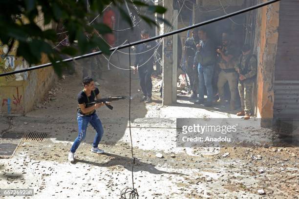 Al-Fatah Movement militants are seen during a fire exchange as clashes between members of Palestinian Fatah Movement and Bilal Badr continues at the...