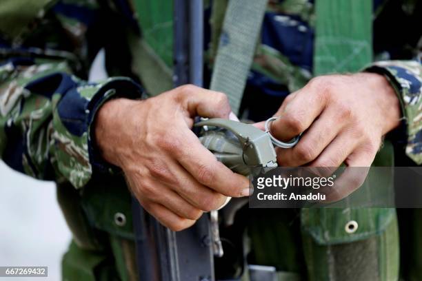 An Al-Fatah Movement militant holds a grenade during a fire exchange as clashes between members of Palestinian Fatah Movement and Bilal Badr continue...
