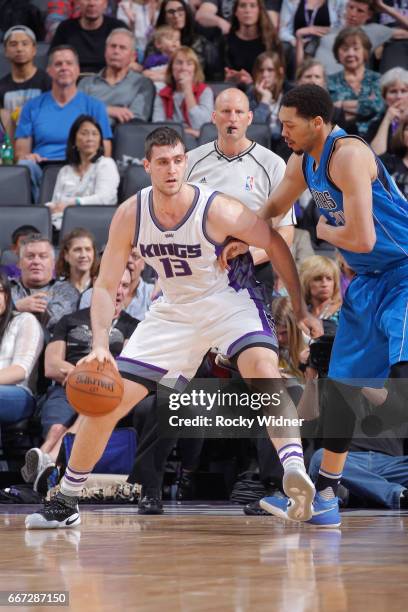 George Papagiannis of the Sacramento Kings handles the ball against AJ Hammons of the Dallas Mavericks on April 4, 2017 at Golden 1 Center in...