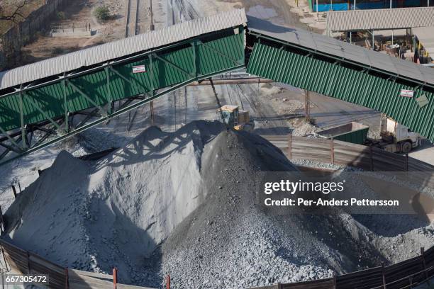 Copper ore is transported on a belt and dropped in a pile before being picked up by trucks for processing at Mopani mines on July 6, 2016 in...