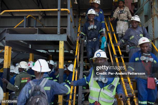 Mine workers arrive from an 8-hour shift mining copper in one of the underground shafts at Mopani on July 6, 2016. Glencore, an Anglo-Swiss...