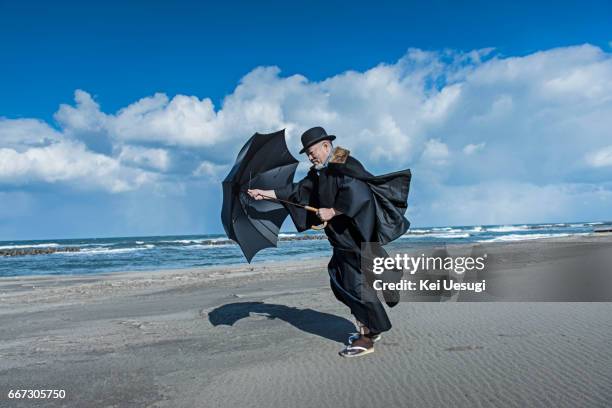 asian senior man - long coat stock pictures, royalty-free photos & images