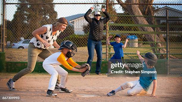 close play at home plate, runner sliding in - home base fotografías e imágenes de stock