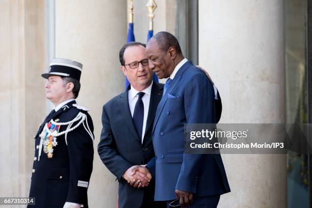 French President Francois Hollande greets President of Guinea Alpha Conde after a meeting at the Elysee Palace on April 11, 2017 in Paris, France....