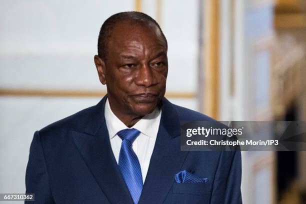 French President Francois Hollande holds a press conference with President of Guinea Alpha Conde after a meeting at the Elysee Palace on April 11,...