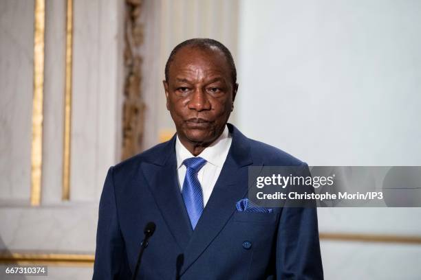 French President Francois Hollande ) holds a press conference with President of Guinea Alpha Conde after a meeting at the Elysee Palace on April 11,...