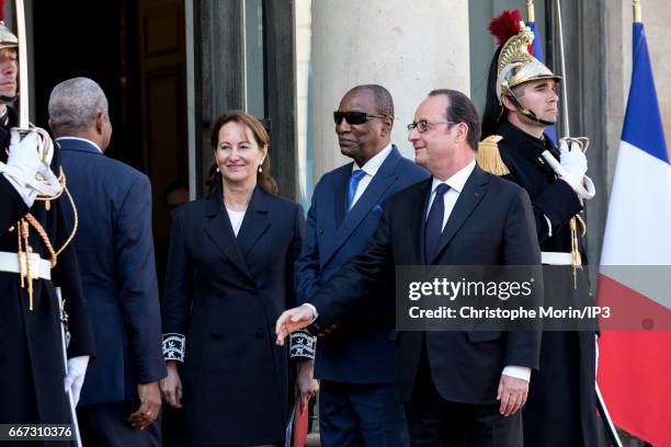 French President Francois Hollande and Environment Minister Segolene Royal welcome President of Guinea Alpha Conde for a meeting at the Elysee Palace...