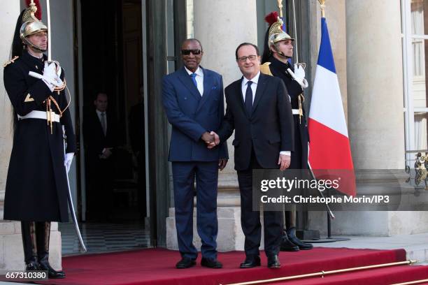 French President Francois Hollande welcomes President of Guinea Alpha Conde for a meeting at the Elysee Palace on April 11, 2017 in Paris, France....