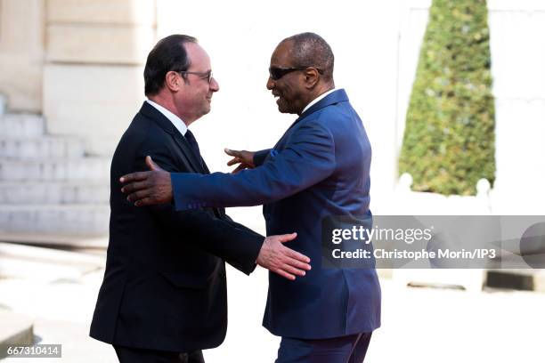 French President Francois Hollande welcomes President of Guinea Alpha Conde for a meeting at the Elysee Palace on April 11, 2017 in Paris, France....