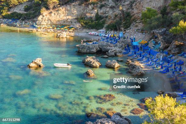 crowded anthony quinn beach, rhodes - anthony quinn bay stock pictures, royalty-free photos & images