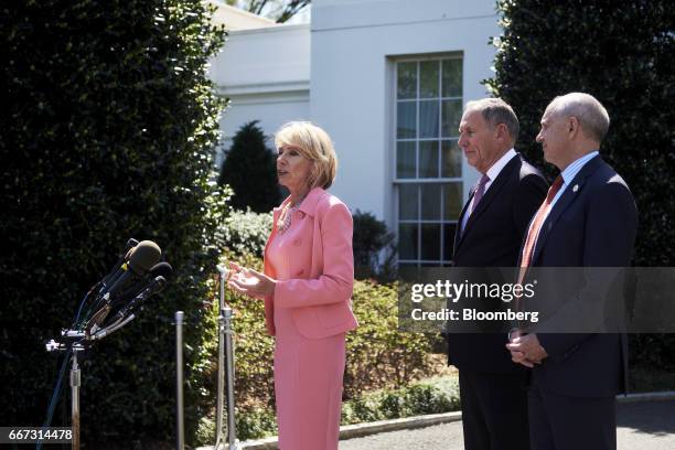 Betsy DeVos, U.S. Secretary of education, from left, speaks to members of the media as Toby Cosgrove, president and chief executive officer of...