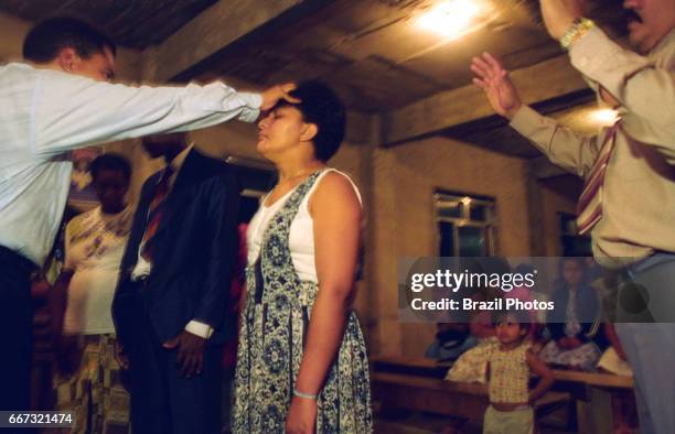 Protestant preacher at a revival meeting in a Pentacostal cult in Favela da Mangueira, Rio de Janeiro, Brazil.