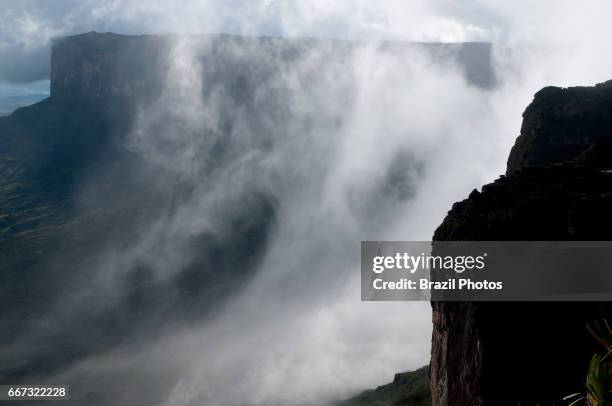 Mist formed by condensation between Mount Kukenan or Mount Cuquenan and Mount Roraima, Venezuela.