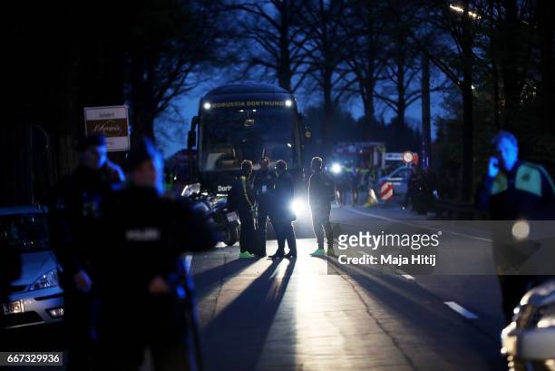 Head coach Thomas Tuchel of Dortmund stands near the team bus of the Borussia Dortmund football club after the bus was damaged in an explosion on...