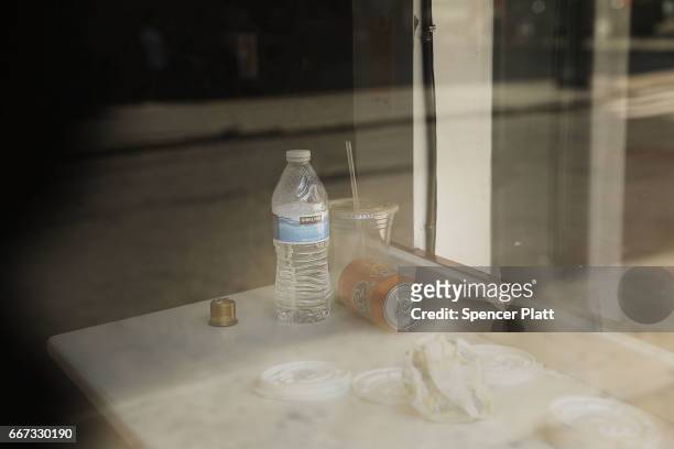 The remains of a meal sit in the window of a shuttered business in a trendy West Village neighborhood on April 11, 2017 in New York City. Many...