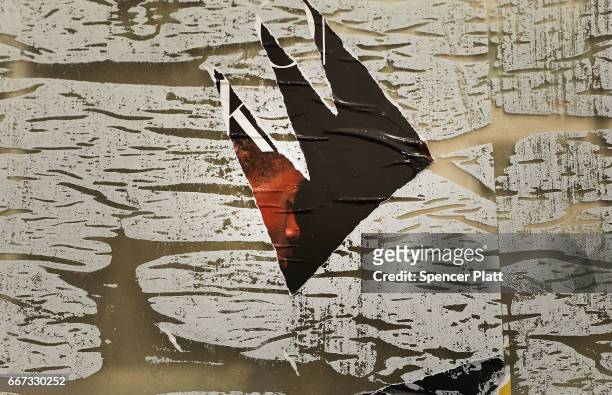 The remains of a poster are visible in the window of an empty store front in a trendy West Village neighborhood on April 11, 2017 in New York City....