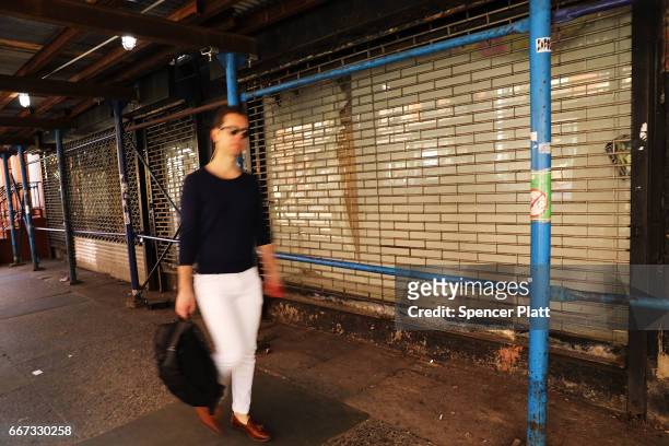 Man walks by empty store fronts in a trendy West Village neighborhood on April 11, 2017 in New York City. Many residents and tourists alike are...