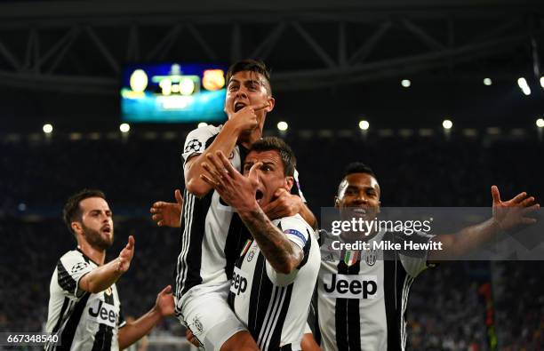 Paulo Dybala of Juventus celebrates with Miralem Pjanic, Mario Mandzukic and Alex Sandro of Juventus after scoring his team's second goal during the...