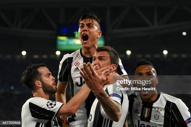 Paulo Dybala of Juventus celebrates with Miralem Pjanic, Mario Mandzukic and Alex Sandro of Juventus after scoring his team's second goal during the...