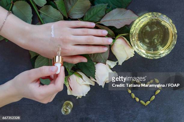 person applying oil for skin - oily skin stock pictures, royalty-free photos & images