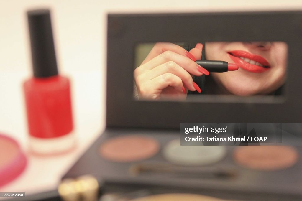 Woman applying lipstick