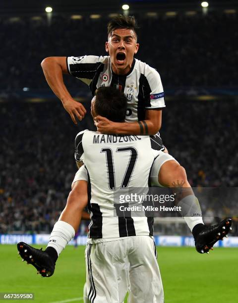 Paulo Dybala of Juventus celebrates with Mario Mandzukic after scoring his team's second goal during the UEFA Champions League Quarter Final first...