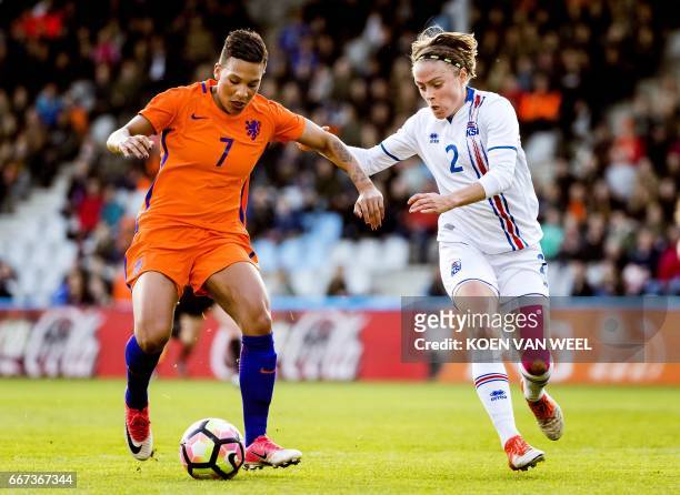 Netherlands' national women football team player Shanice van de Sanden vies with Iceland's national women football team player Sif Atladottir during...