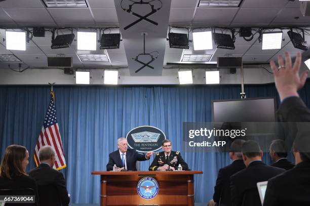 Secretary of Defense James Mattis and US Central Command Commander Joseph Votel take part in a briefing at the Pentagon in Washington, DC on April...