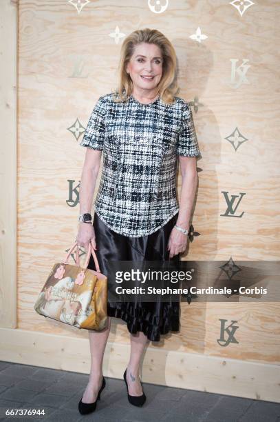 Actress Catherine Deneuve attends the Louis Vuitton's Dinner for the Launch of Bags by Artist Jeff Koons at Musee du Louvre on April 11, 2017 in...