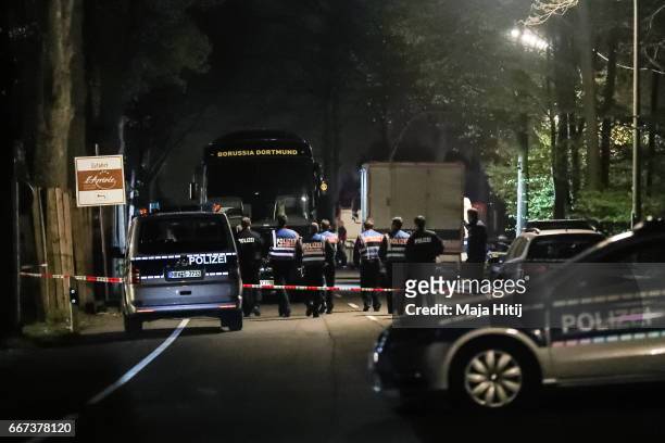 Police stand near the team bus of the Borussia Dortmund football club after the bus was damaged in an explosion on April 11, 2017 in Dortmund,...