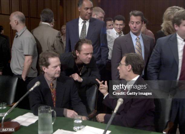 Roger McGuinn, a member of The Byrds, seated left, Lars Ulrich of Metallica center, Hank Barry CEO Napster seated right, share words before the...