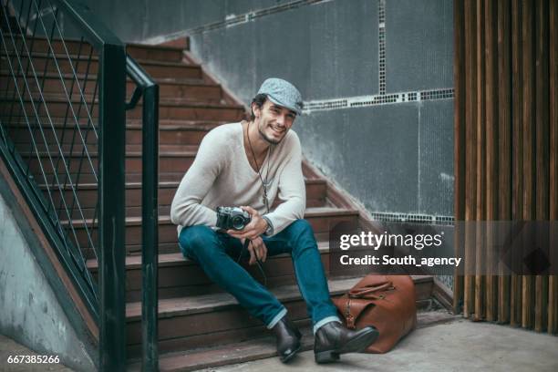 smiling guy with a camera - fashion photographer stock pictures, royalty-free photos & images