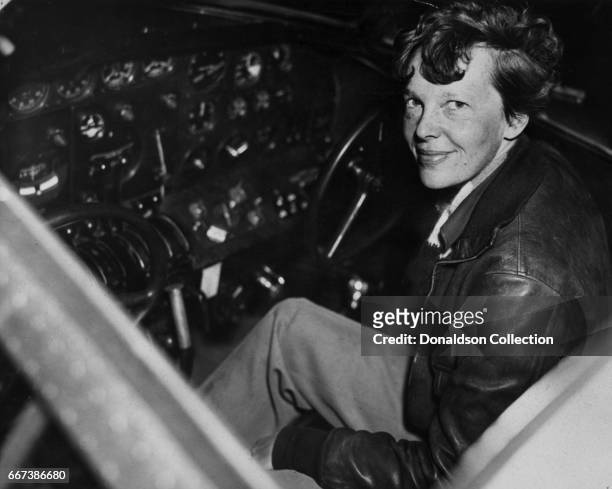 Pilot Amelia Earhart poses for a portrait in the cockpit of an Electra Airplane in circa 1935.
