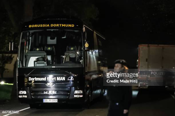 Police stand near team bus of the Borussia Dortmund football club after it was damaged in an explosion on April 12, 2017 in Dortmund, Germany....