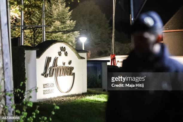 Police stand near the team hotel after the bus of Borussia Dortmund was damaged in an explosion on April 12, 2017 in Dortmund, Germany. According to...