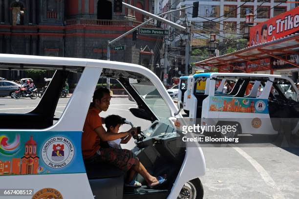 Driver rides a Bemac Electric Transportation Philippines Inc. E-Trike electric tricycle towards a charging station in Manila, the Philippines, on...