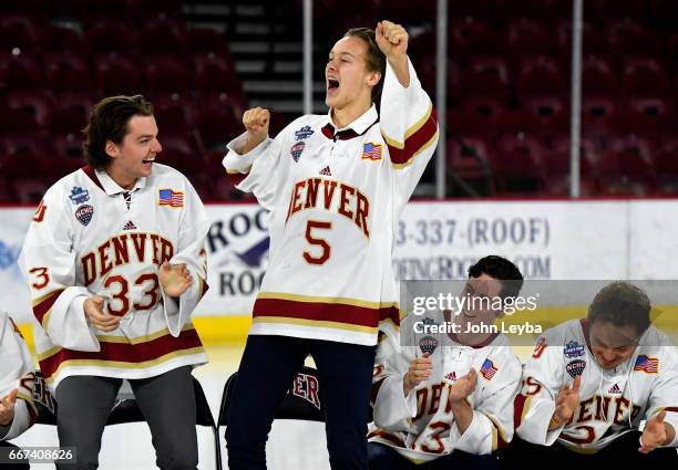 Denver Pioneers goalie Patrick Munson and Denver Pioneers forward Henrik Borgström lead the team in a song during the Denver Pioneers men's hockey...