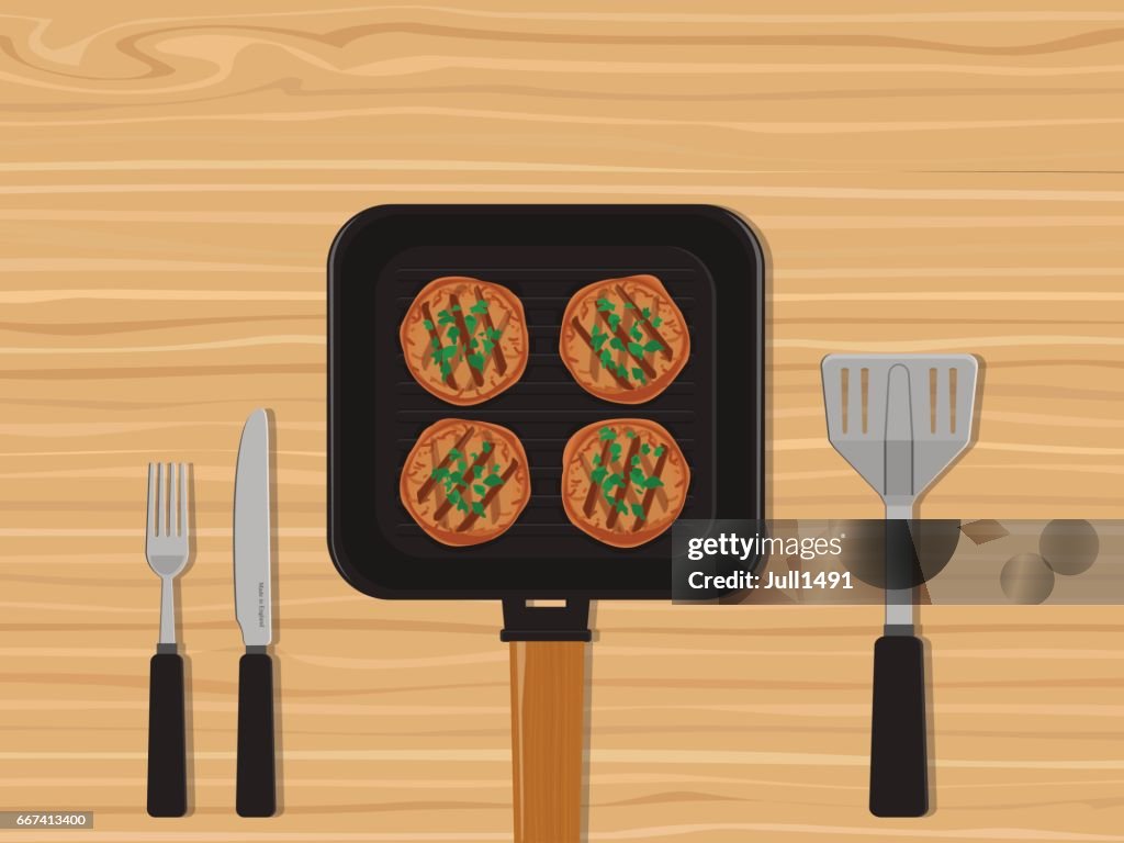 Asar los filetes en la bandeja en una mesa de madera.