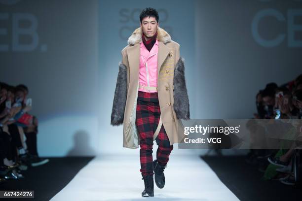 Retired hurdler Liu Xiang showcases designs on runway at the SOLO CELEB. & HTDG collection by Leo Ku during Shanghai Fashion Week Autumn/Winter 2017...