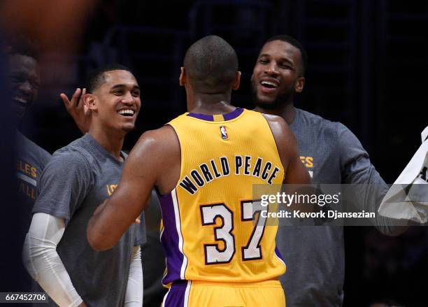 Metta World Peace of the Los Angeles Lakers, who ended up scoring a team-high 18 points, is congratulated by teammates Jordan Clarkson and Thomas...