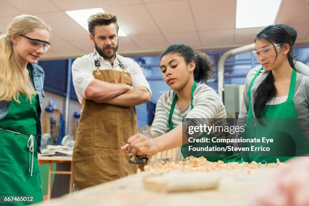 carpentry teacher and students working in workshop - woodshop stock pictures, royalty-free photos & images