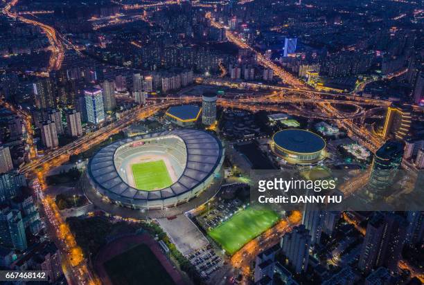 aerial view of shanghai stadium in xuhui district - aerial football photos et images de collection