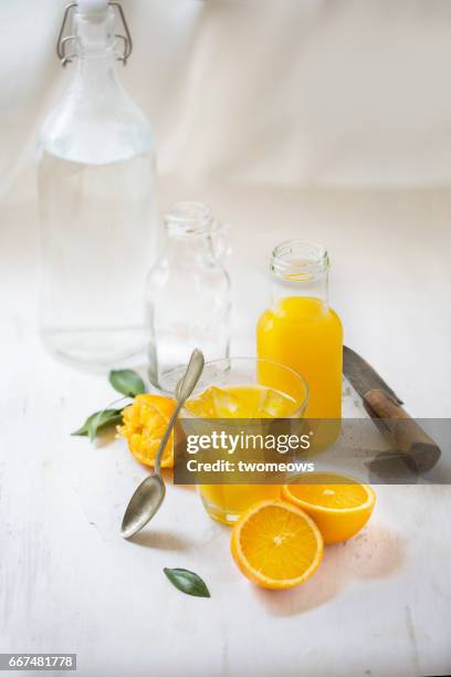 orange juice on white rustic background. - orange juice glass white background stock-fotos und bilder