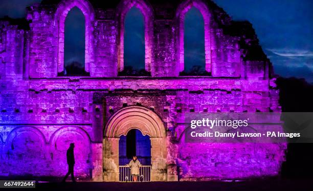 Illuminations on parts of the ruins during the Brocken Spectre light and sound event at Rievaulx Abbey on the North York Moors.