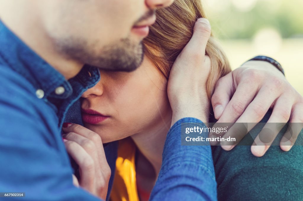 Young man comforting his girlfriend