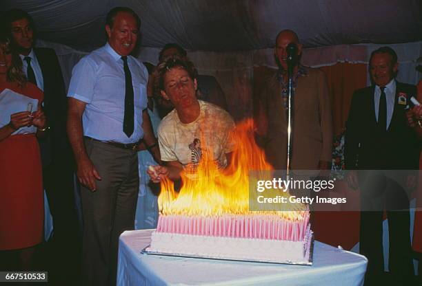 American tennis player Chris Evert attempts to blow out the candles on a cake celebrating her 1000th match win, at the Australian Open, Melbourne,...